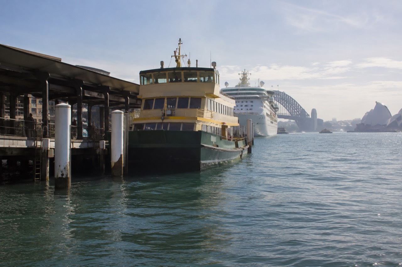 Sydney Harbour ferry and cruise boats moored at Circular Quay on a clear morning