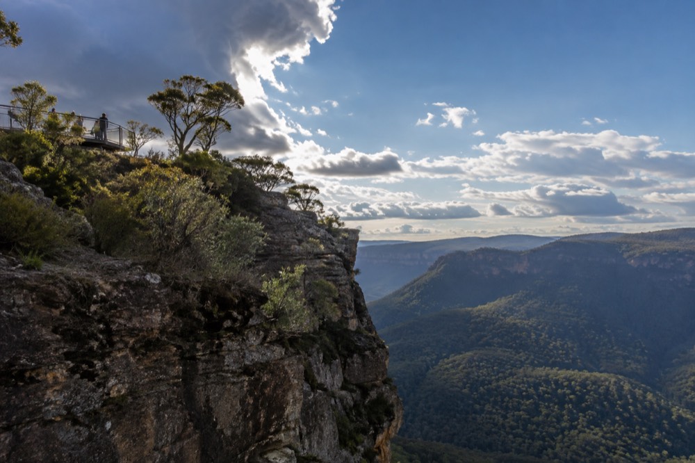 A cliffside lookout platform above a deep forested valley in the Blue Mountains