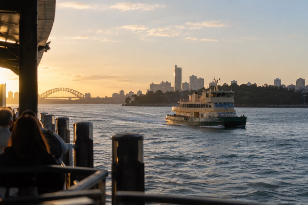 A ferry crossing Sydney Harbour with the zoo headland and city skyline in view