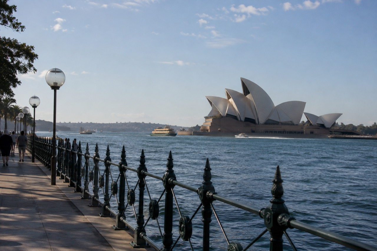 Sydney Opera House sails and harbour water seen from Circular Quay at midday