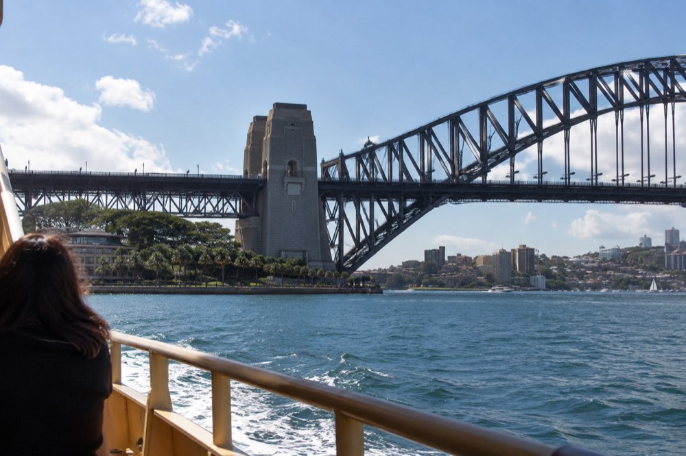 The south pylon and steelwork of Sydney Harbour Bridge from a ferry deck on the water