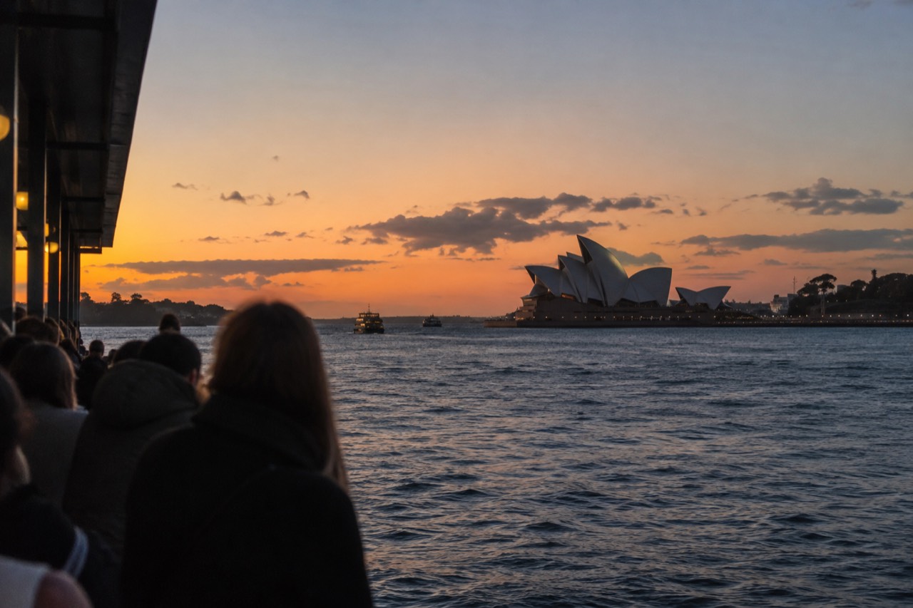 Sydney Opera House sails seen across the water from Circular Quay at dusk
