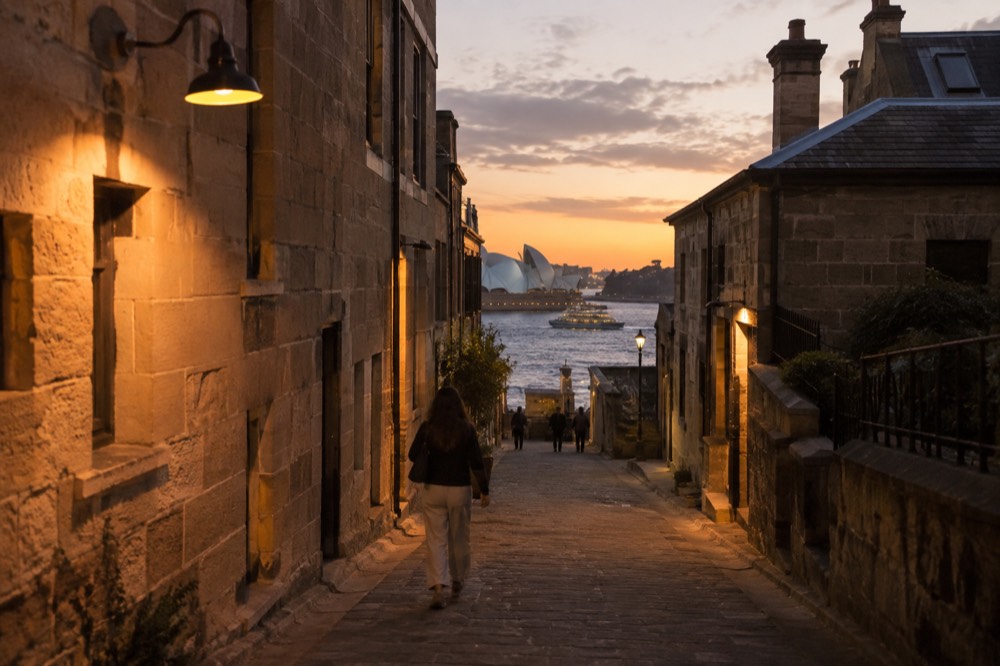 Laneway in The Rocks at dusk with warm light on sandstone walls