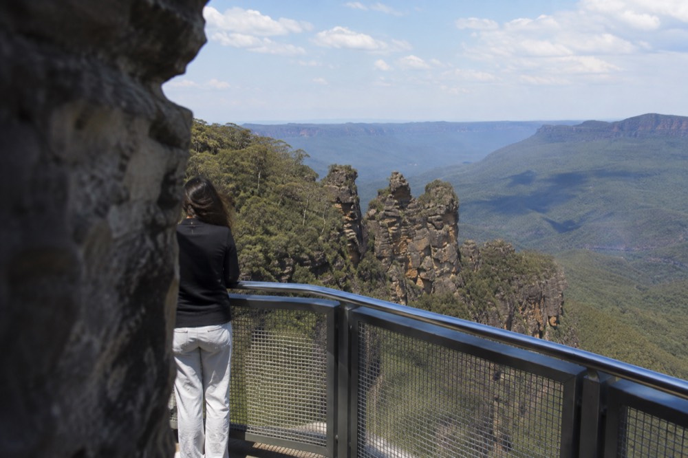 The Three Sisters rock formation viewed across a forested gorge at Katoomba