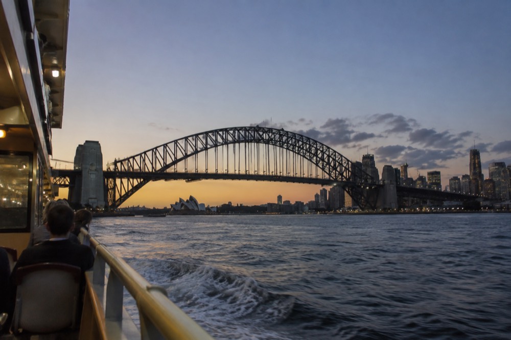 Sydney Harbour Bridge and city skyline seen from a ferry on the water