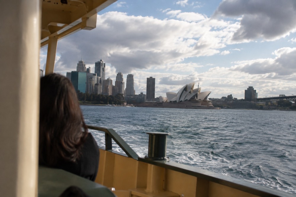 Sydney Harbour seen from a ferry, with the Opera House and city skyline across the water