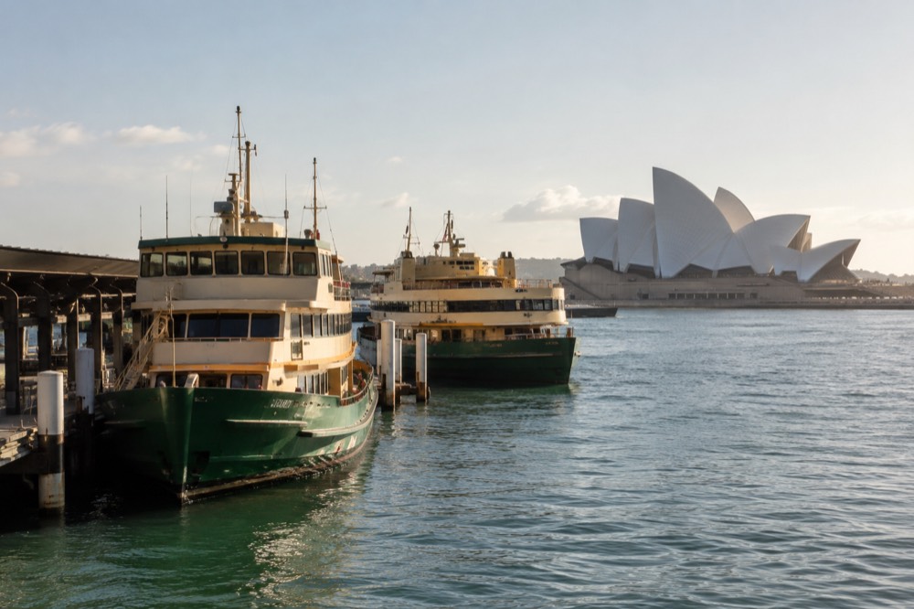 Ferries moored at Circular Quay with the Opera House in the background on a bright afternoon