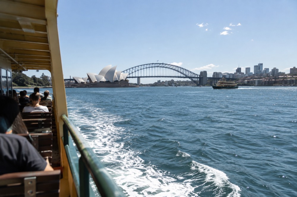Sydney Harbour seen from a ferry, with the Opera House and city skyline in the background