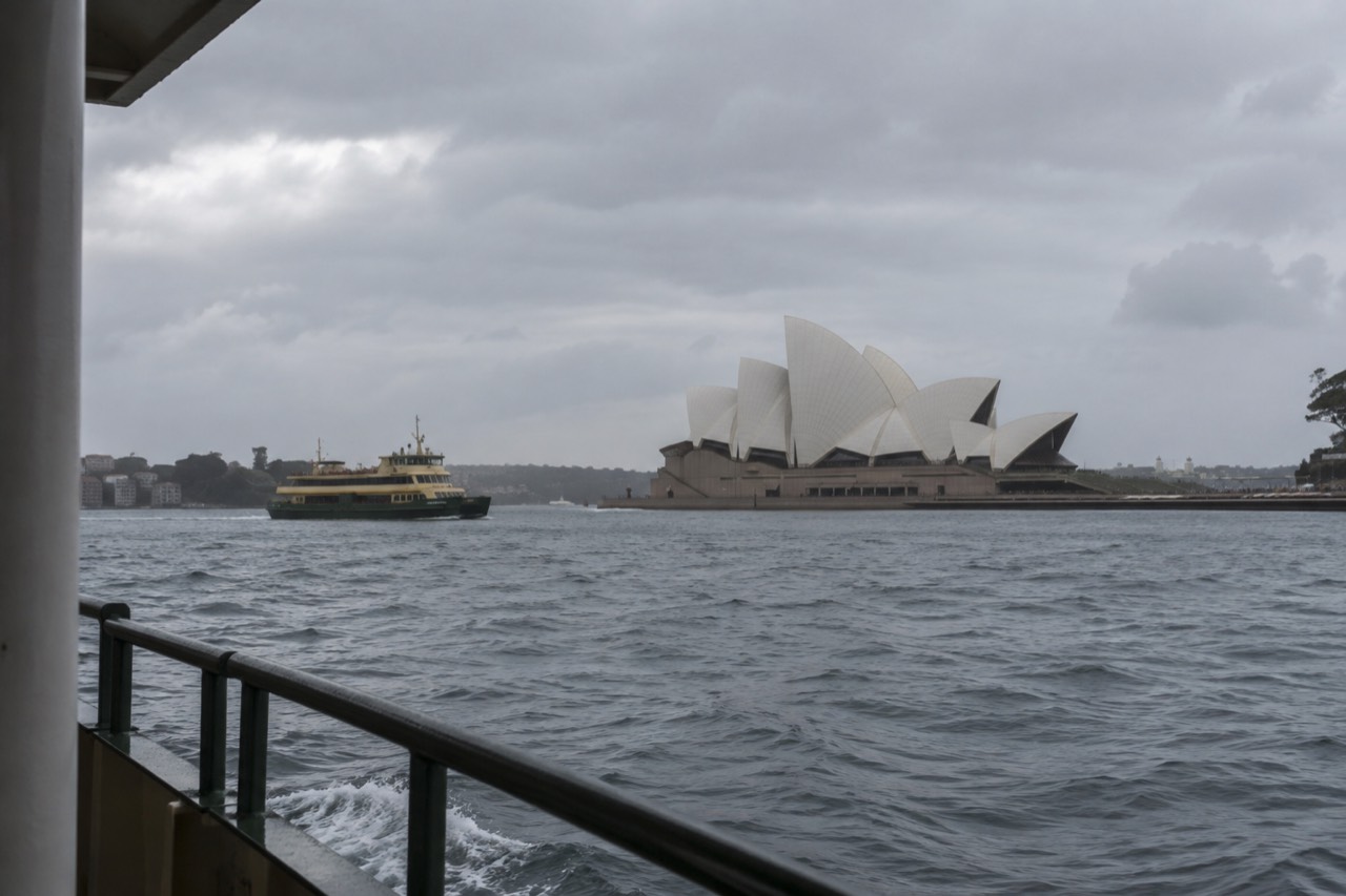 The white sails of the Sydney Opera House seen from the harbour water at Circular Quay