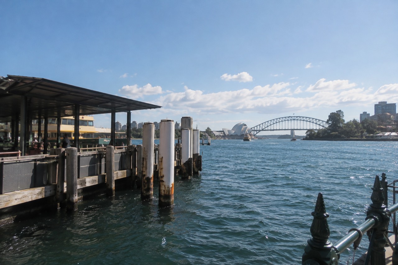 Sandstone headland park lawns overlooking moored yachts on Sydney Harbour at late afternoon