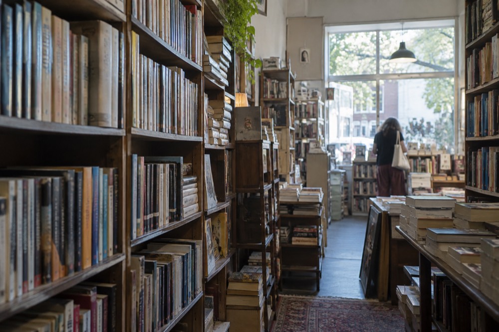 A secondhand bookshop interior with shelves of paperback books