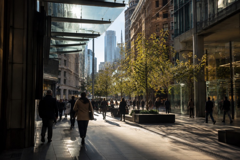 Pitt Street Mall shoppers under glass canopy with city towers behind