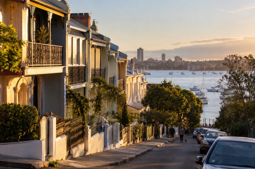 Sunlit heritage terrace houses on a quiet street above the bay
