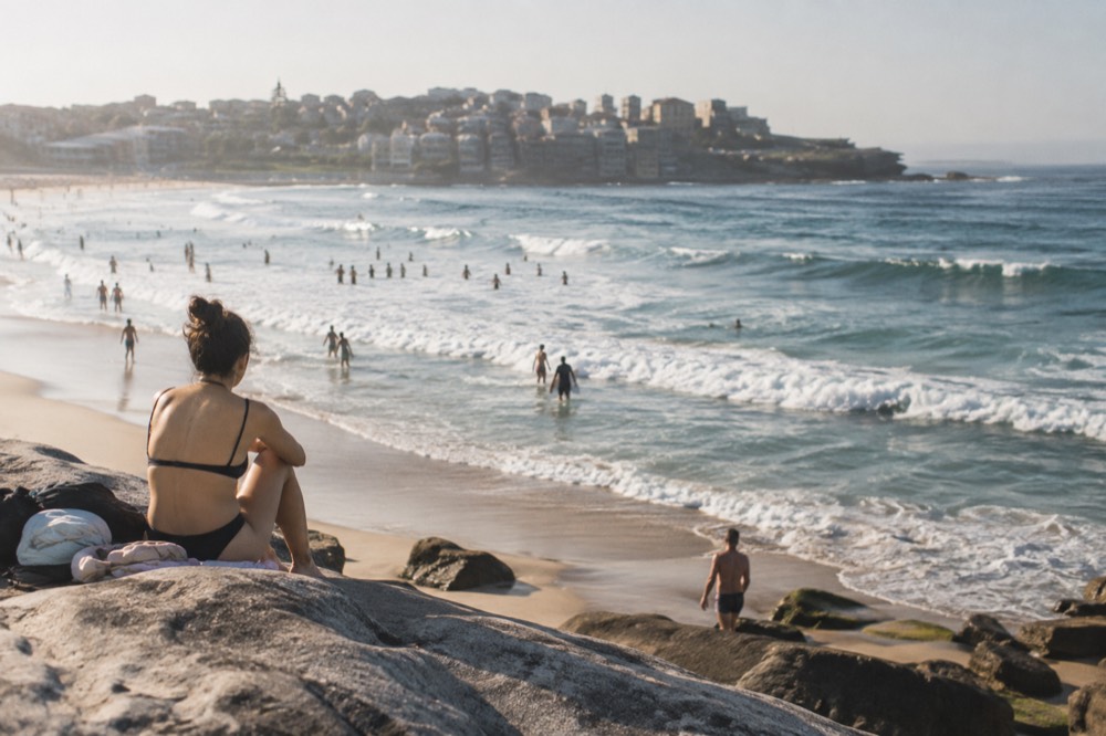 Bondi Beach curving between sandstone headlands with waves breaking near the shoreline