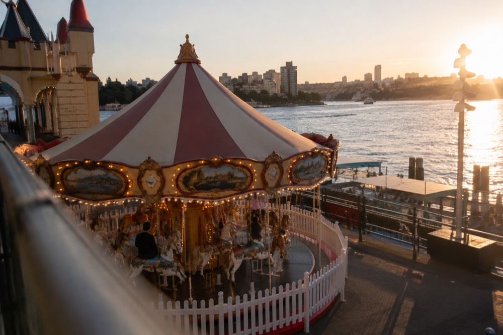 A small vintage carousel with painted horses in an amusement park