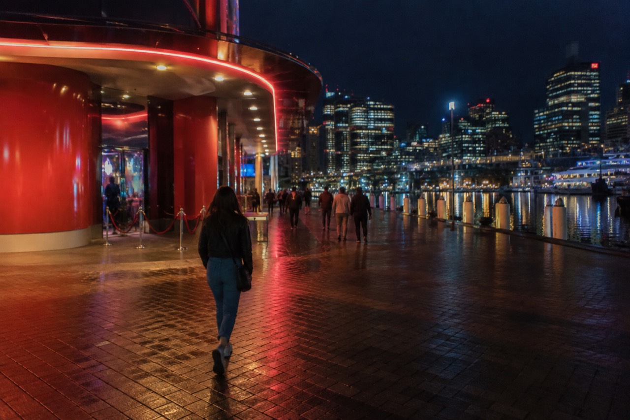 The neon-lit entrance of a wax museum on the Darling Harbour waterfront at dusk