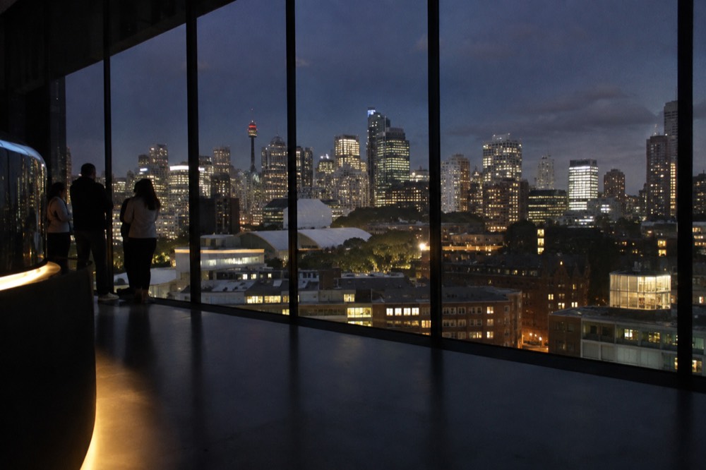 The illuminated Sydney city skyline seen from a high observation deck at dusk