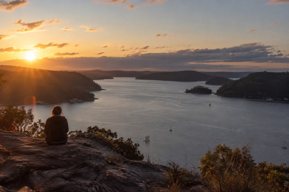 Sunlight over the Hawkesbury estuary from a sandstone ridge at dusk