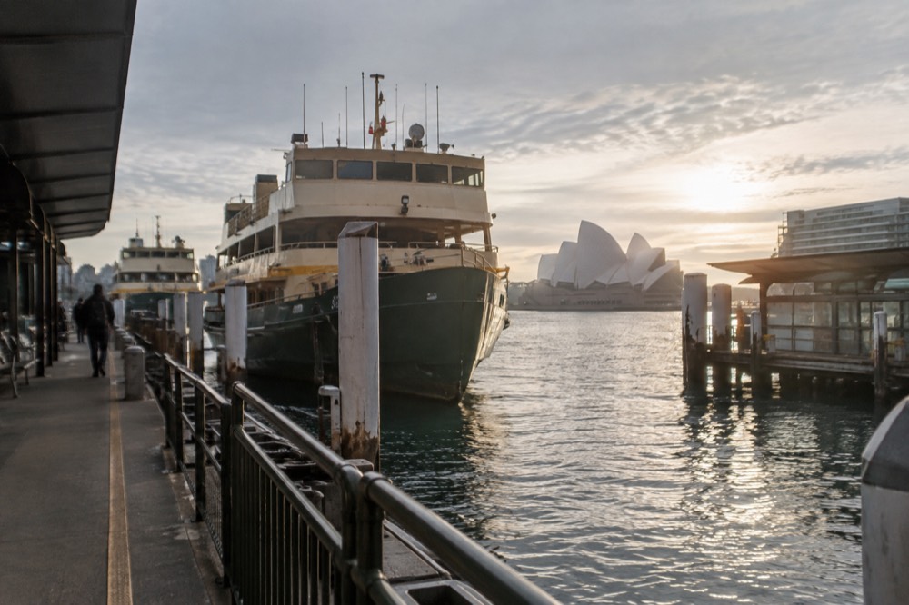 Empty winter morning ferry terminal at Circular Quay with moored ferries and low sun