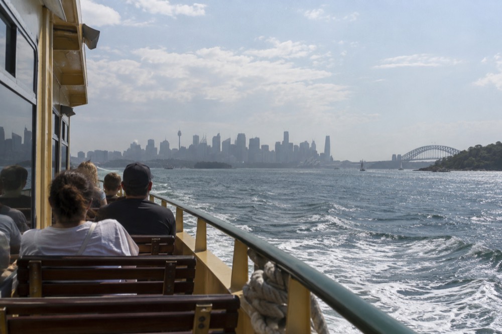 Manly ferry crossing Sydney Harbour with the city skyline behind