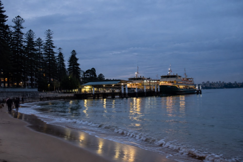 Two ferries berthed side by side at a wharf with gangplanks down