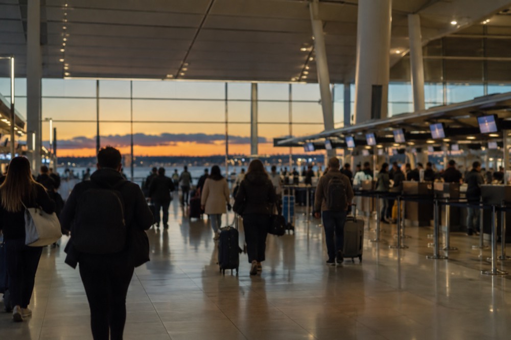 The departure hall of Sydney Airport's international terminal with travellers and check-in counters