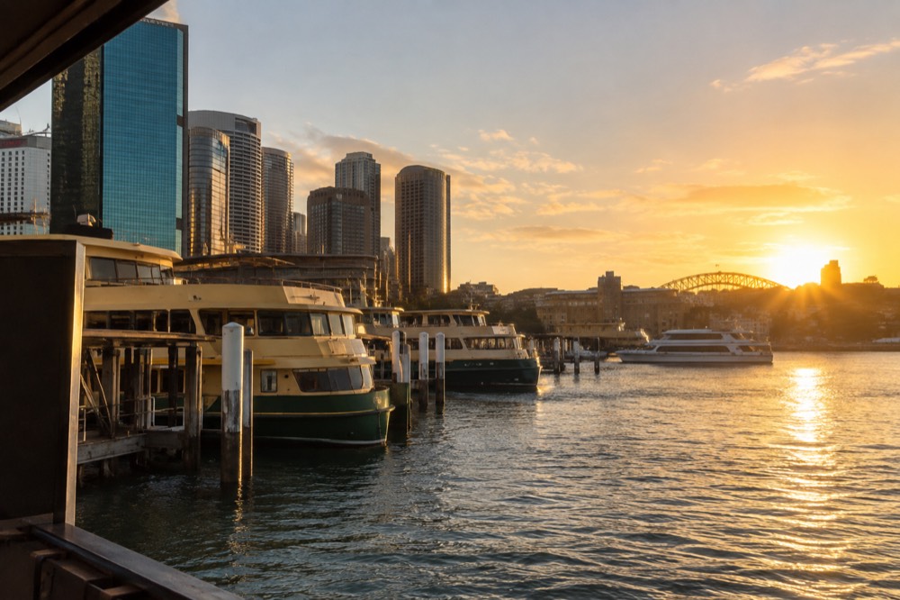 Ferries and boats moored at Circular Quay wharves with the city behind them