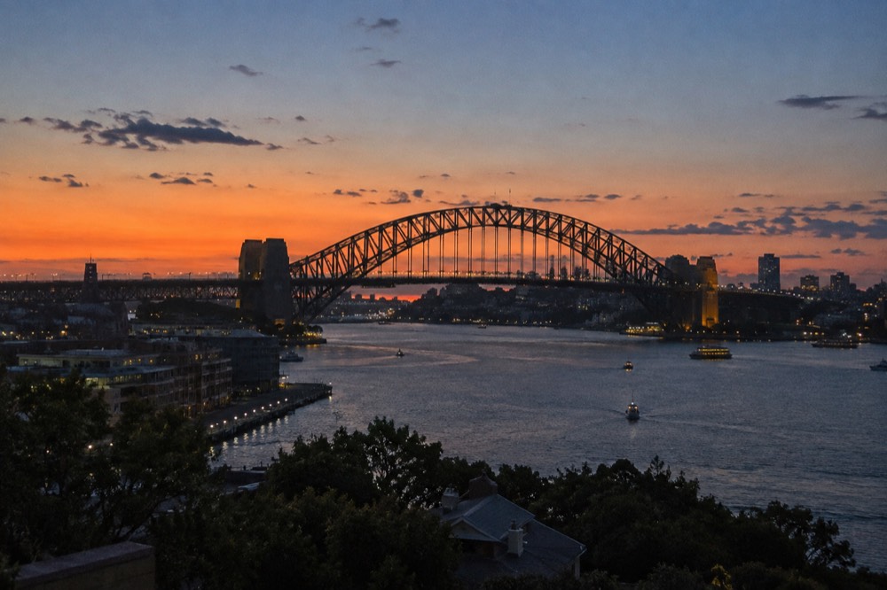 The Sydney Harbour Bridge in silhouette at sunset seen from Observatory Hill