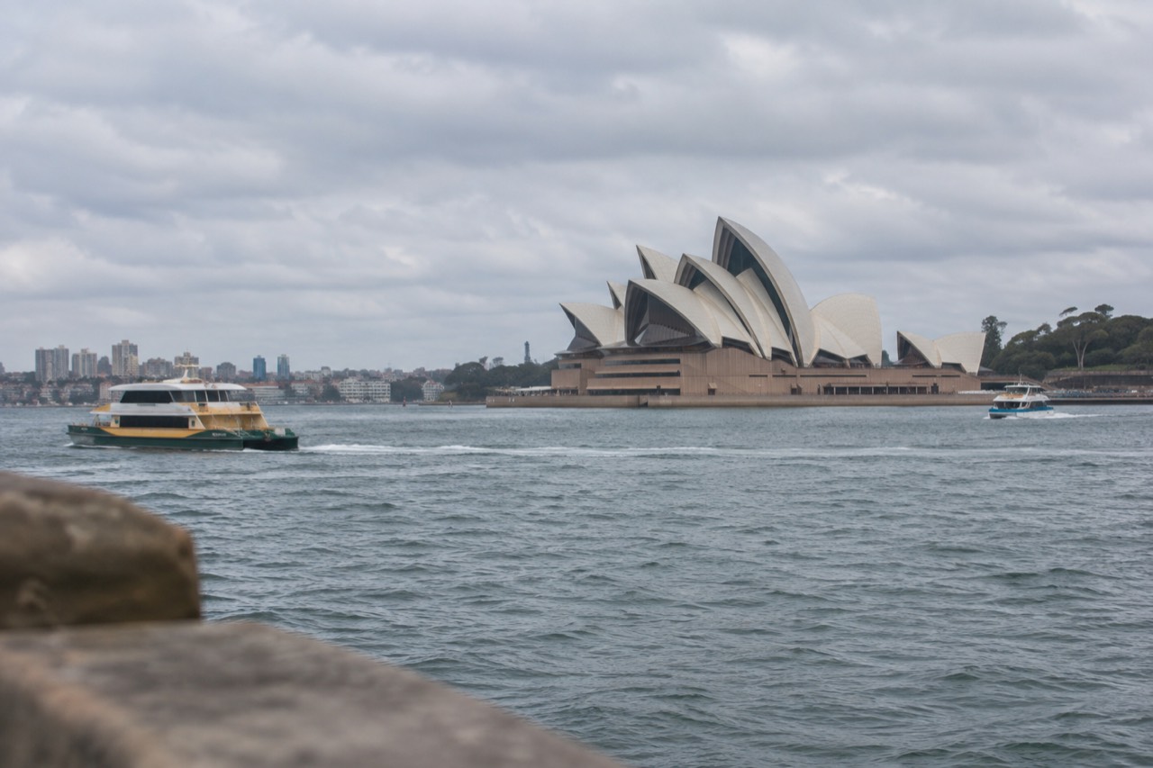Sydney Opera House and harbour viewed across the water on a bright morning