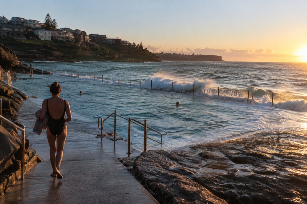 Bronte ocean pool with calm water and grassy headland in the late afternoon
