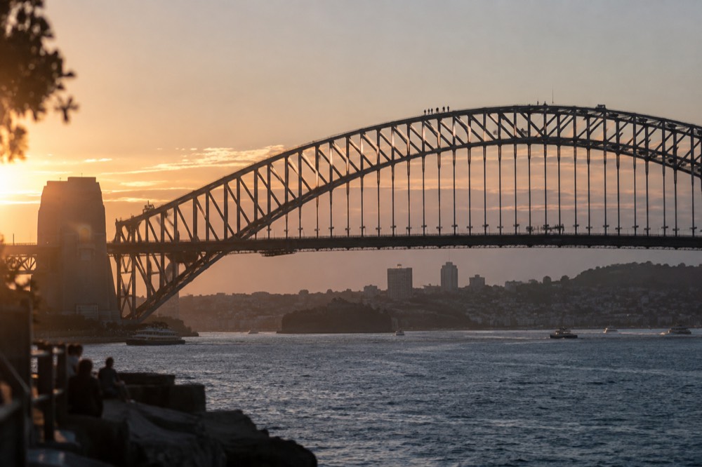 Climbers on the upper arch of the Sydney Harbour Bridge at twilight