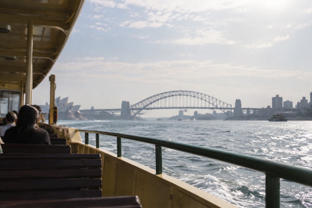 Ferry crossing Sydney Harbour with the Harbour Bridge in the background