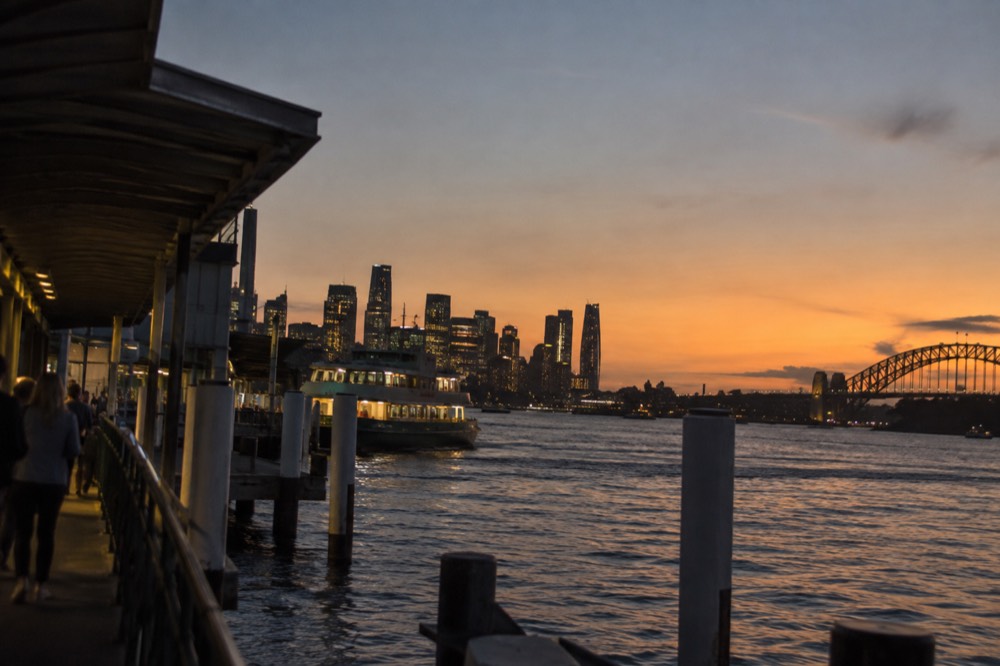Sydney city skyline and harbour seen from Kirribilli at dusk