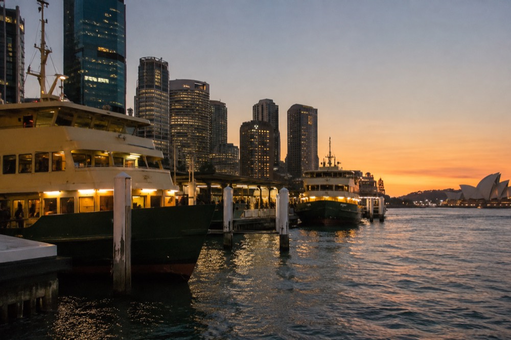 Ferries moored at Circular Quay with the city skyline behind them
