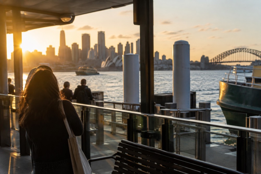 Sydney skyline in warm evening light seen across the harbour