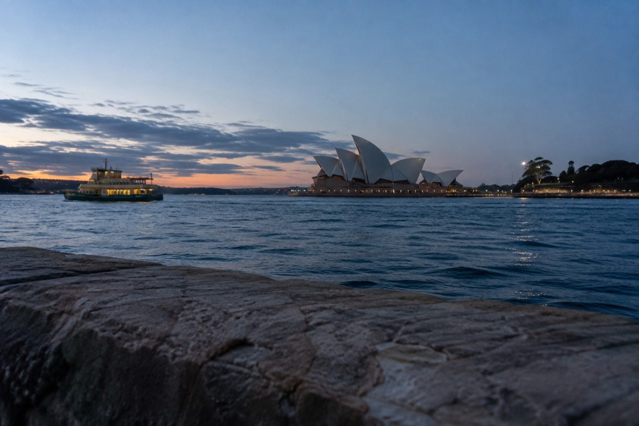 Sydney Opera House sails seen across Circular Quay water on a clear morning
